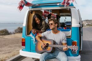 Rodnae Producyions - Free Images https://www.pexels.com/photo/a-woman-lying-in-the-van-watching-a-man-play-the-guitar-8231188/